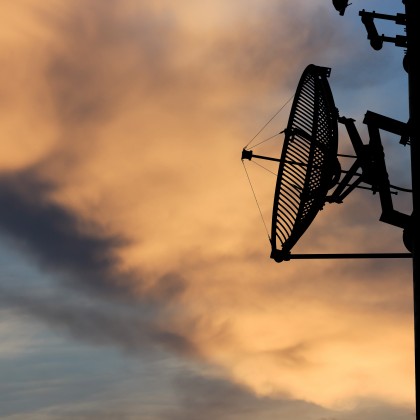 silhouette satellite communication tower poles on sunset